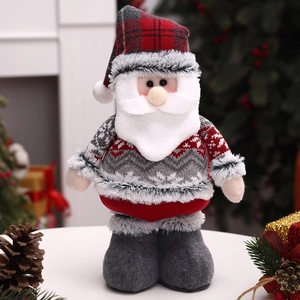 Detail of Santa Claus plush doll with red plaid hat and knitted snowflake sweater