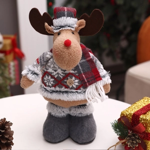 Detail of Christmas reindeer plush doll with red plaid hat and warm grey snowflake sweater