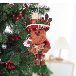 Plush Christmas reindeer ornament with red plaid hat and scarf hanging on a festive tree
