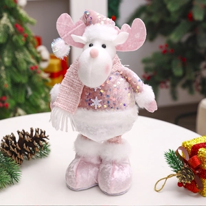 Detail of pink Christmas reindeer doll with sequins and white plush boots on festive background