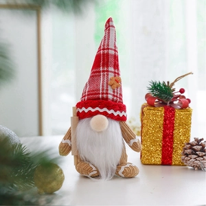 Close-up of a Christmas gnome doll with gingerbread hat and mini wooden rolling pin