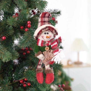 Detailed view of snowman plush pendant with red boots on a festive Christmas tree
