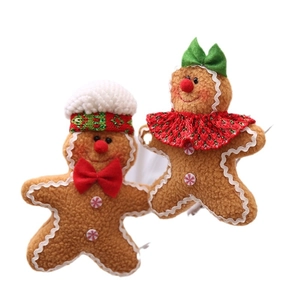 Charming plush gingerbread man and woman figurines with festive hats and lace collars