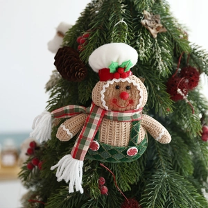 Gingerbread man plush hanging ornament with chef hat on a decorated Christmas tree