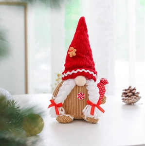 Close-up of a festive Christmas gnome plush with red knit hat and brown corduroy body