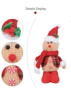 Detail display showing stitching and textures of the gingerbread plush doll with red scarf