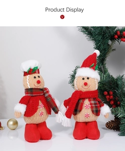 Detail of two knitted gingerbread dolls with festive hats and scarves for Christmas decor