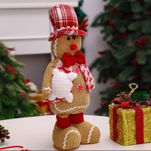 Detail of gingerbread man plush decor featuring red plaid hat and corduroy fabric texture