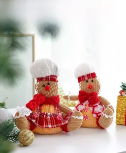 Detail showing glowing plush gingerbread man dolls with warm light on velvet fabric