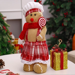 Detail view of gingerbread plush with chef hat and candy cane in a cozy Christmas setting