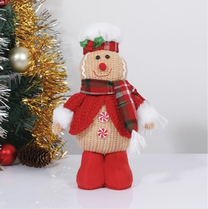 Close-up of knit gingerbread doll with red scarf and chef hat for Christmas decor