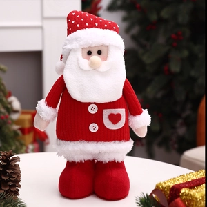 Close-up of a Santa plush doll with red knit hat and plush white beard in home setting