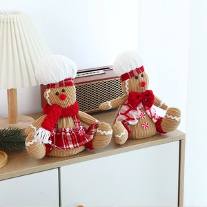 Detail of plush gingerbread couple with corduroy texture and festive Christmas outfits