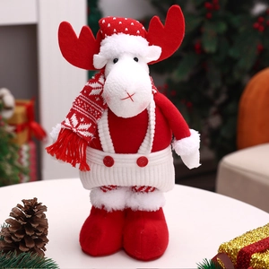 Detailed view of a Christmas reindeer plush toy with red hat and knitted snowflake scarf