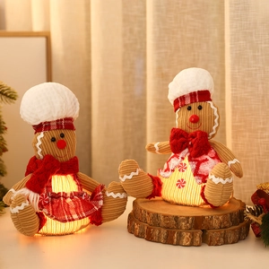 Close-up of lighted chef gingerbread man plush with brown corduroy and warm LED glow