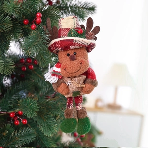 Christmas reindeer plush ornament with red plaid hat hanging on a festive Xmas tree