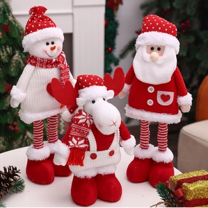 Close-up of knitted Christmas plush set featuring Santa Claus, reindeer, and snowman dolls