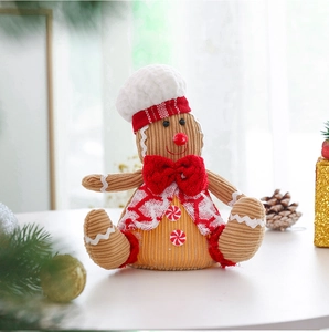Close-up of a gingerbread man plush toy with chef hat and festive bow for Christmas decor