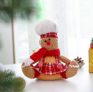 Detail of gingerbread man chef doll with brown striped fabric and red knit scarf decor