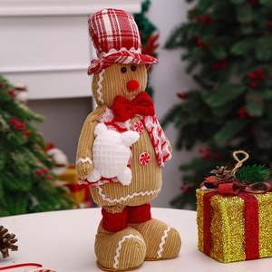 Standing gingerbread man plush with festive hat and scarf for Christmas table decoration