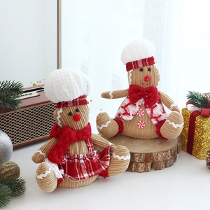 Pair of glowing gingerbread man plush dolls with chef hats for Christmas window decor