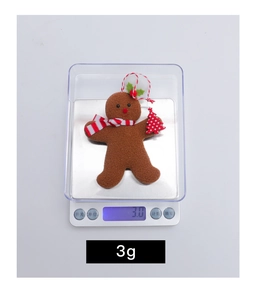 Close-up of a lightweight 3g gingerbread man felt ornament with a red striped scarf