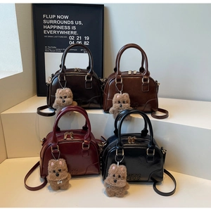 Multiple vintage glossy bowling bags in black, coffee, brown and wine red with bear charm