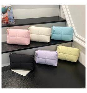 Selection of colorful puffer style clutches with cross-quilted patterns and metal zippers