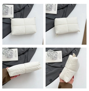 Detailed views of a white quilted puffy clutch bag showing the soft texture and zipper