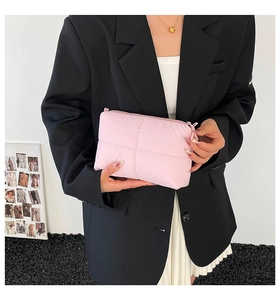 Pink quilted puffer clutch bag with square stitching and top zipper closure