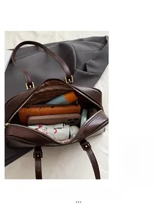 Interior view of brown vintage Boston bag showing large capacity and striped lining