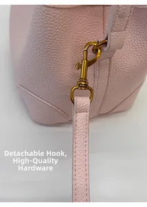 Close-up of pink litchi grain leather bag with detachable vintage gold metal swivel hook