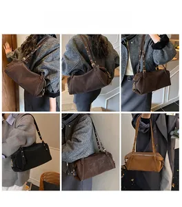 Detail view of retro cylindrical shoulder bags in dark brown and black matte finish