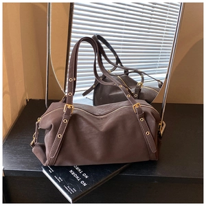 Mirror reflection showing front and back detail of dark brown suede Boston bag
