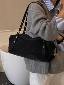 Retro black cylindrical tote bag for women with metal eyelets on shoulder strap
