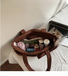 Top view of spacious brown tote bag interior showing capacity with various personal items