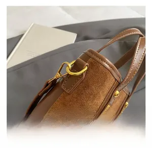 Détails du crochet doré et des coutures fines sur le sac à main en cuir marron