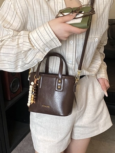 Vintage dark brown leather bucket bag with wooden beads and adjustable shoulder strap