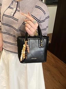 Retro black PU leather bucket bag with wooden beads decoration and golden hardware details