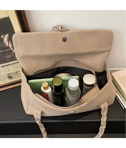 Detail view of large tote bag interior showing spacious storage for tablets and cosmetics