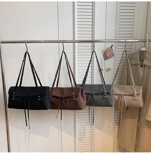 Detail view of large tote bags in four colors with woven straps and bow accents