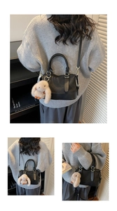 Detail of black crossbody bag featuring textured grid stitching and a cute bunny charm