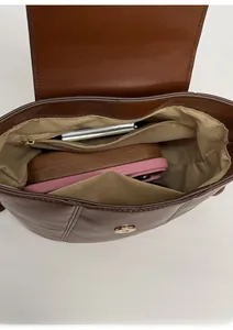 Macro view of interior storage with zipper pocket in a brown leather shoulder bag