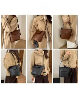 Detail view of stylish leather bucket bags with unique twin-ball charms in black and brown