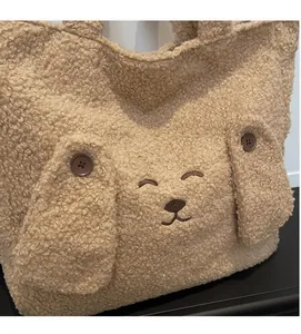 Close-up of fluffy teddy fleece tote bag with cute embroidered bear face and button ears