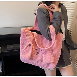 Close-up of pink plush tote bag showing soft fleece texture and cute animal embroidery