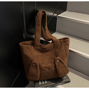 Detail of cute brown plush tote bag with lamb wool texture and 3D long ear bunny decor