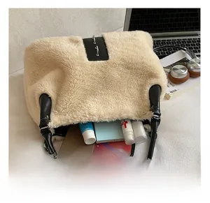 Detail showing the inner capacity of the plush tote bag with phone and skincare products