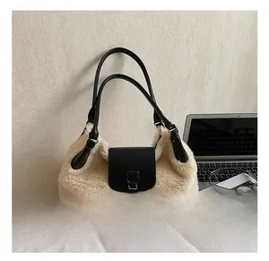 Detail showing plush cream faux fur tote bag with black leather handle and metal chain