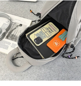 Detail view of the spacious inner compartment of this grey nylon commuter backpack